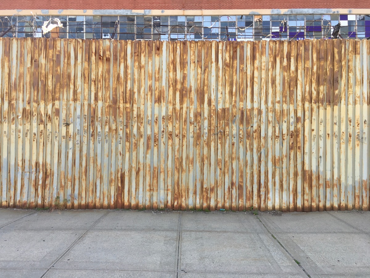 Metal wall with brass stains all over it