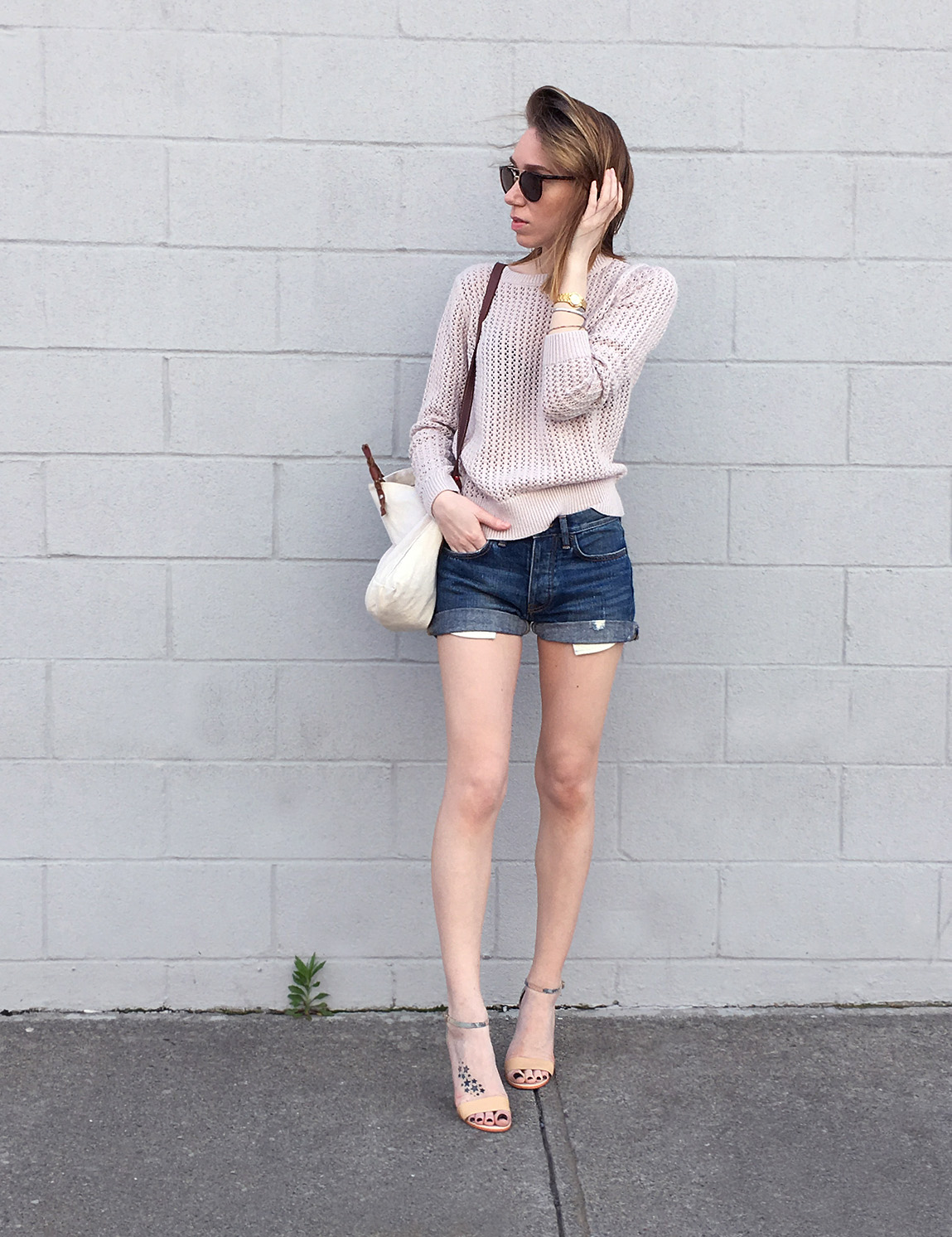 Pink sweater with denim shorts and heels outfit