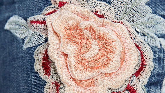 Jeans with 3D flower embroidery closeup