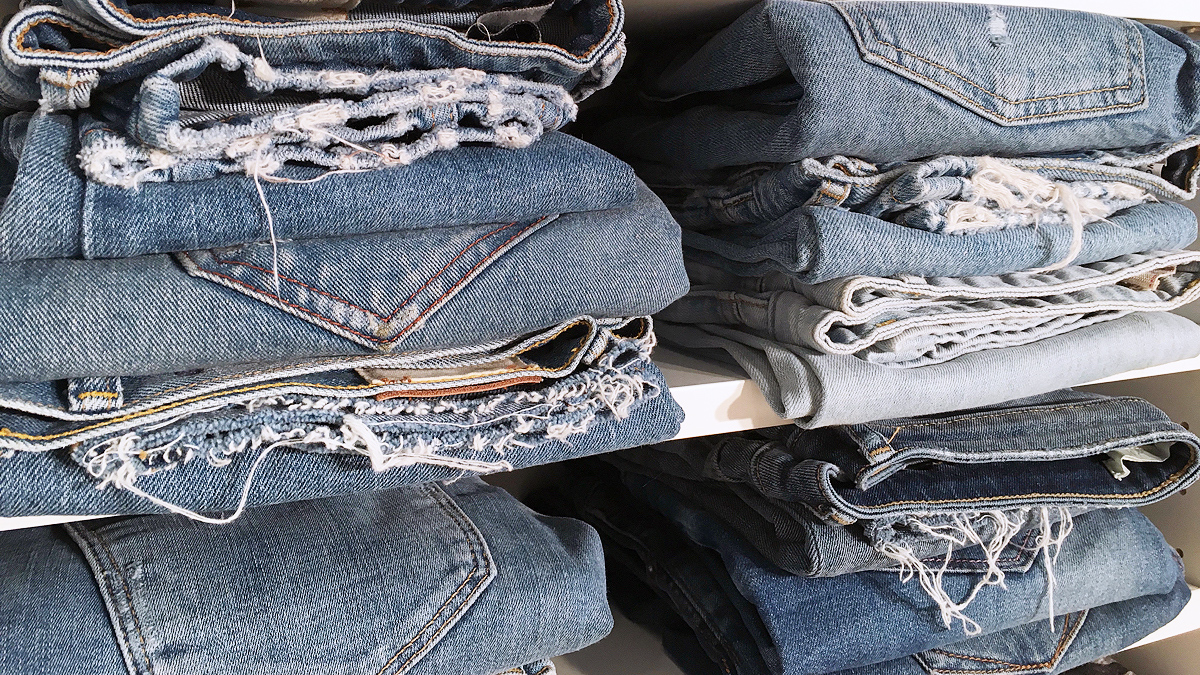 Jeans folded on shelves