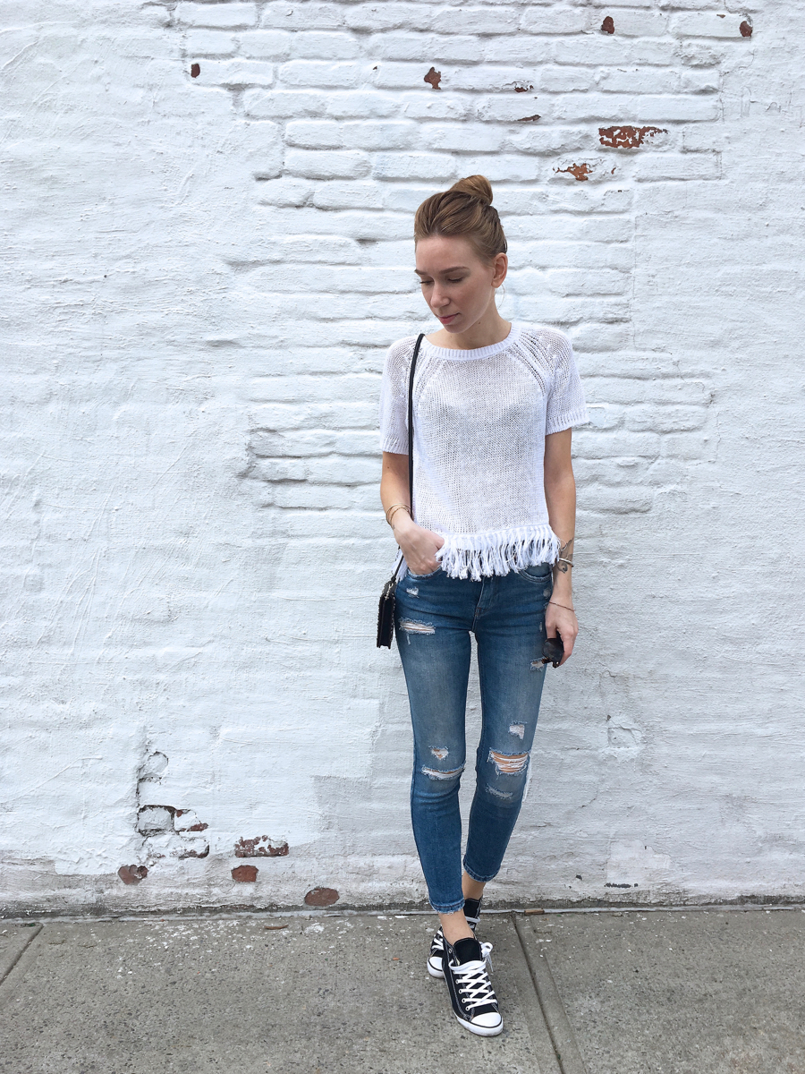 White top with denim and sneakers outfit