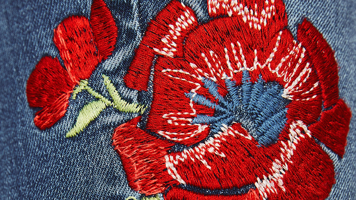 Zara jeans with red embroidered zoom in detail