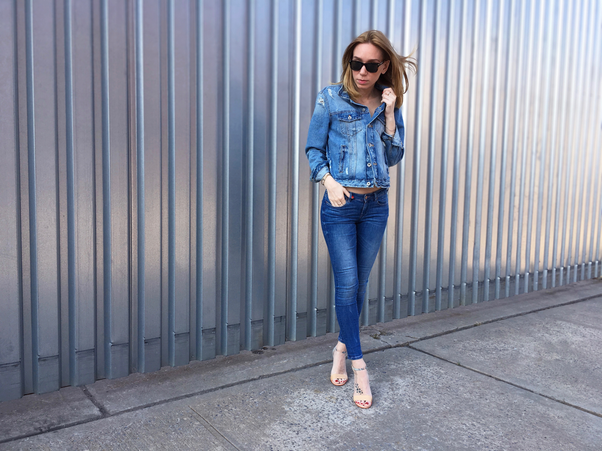 Girl wearing denim jacket and jeans outfit posing 