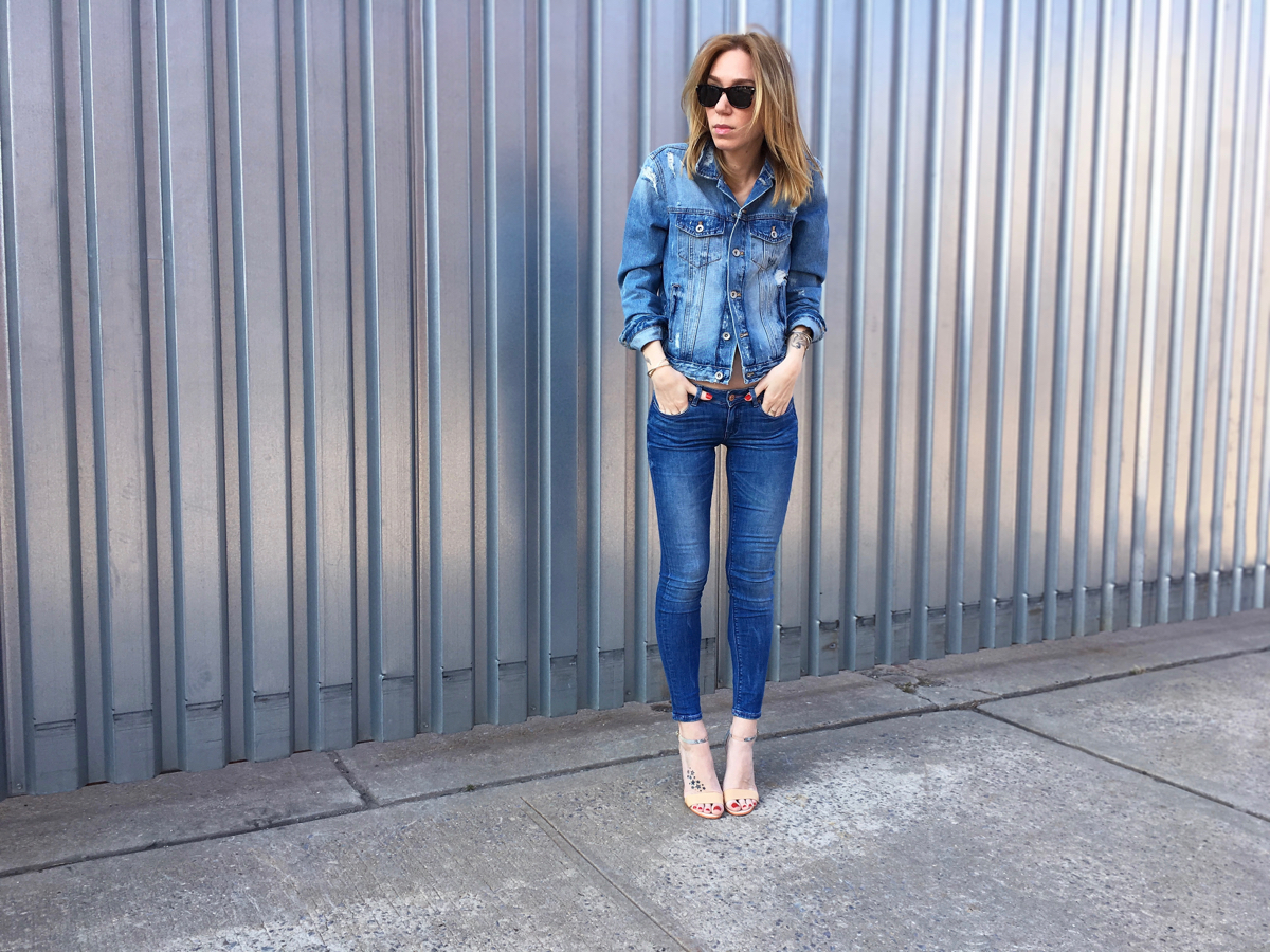 Girl wearing denim jeans and denim jacket outfit posing with hands in pocket