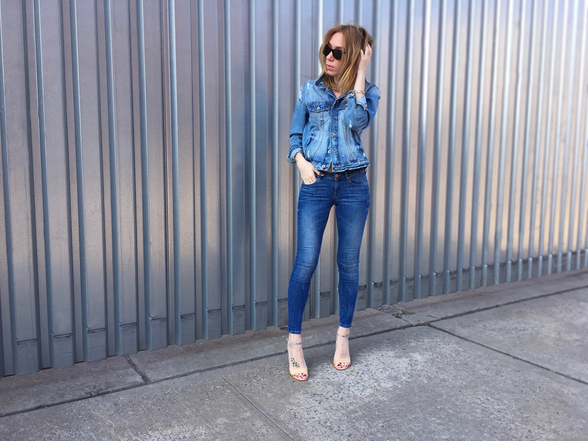 Girl wearing denim jacket and denim jeans outfit posing outside