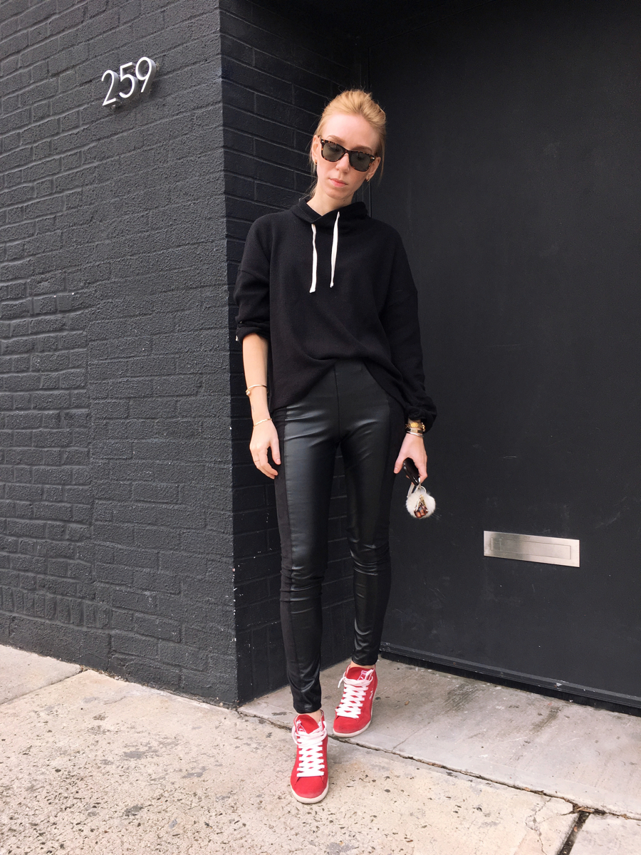 Woman standing wearing all black outfit