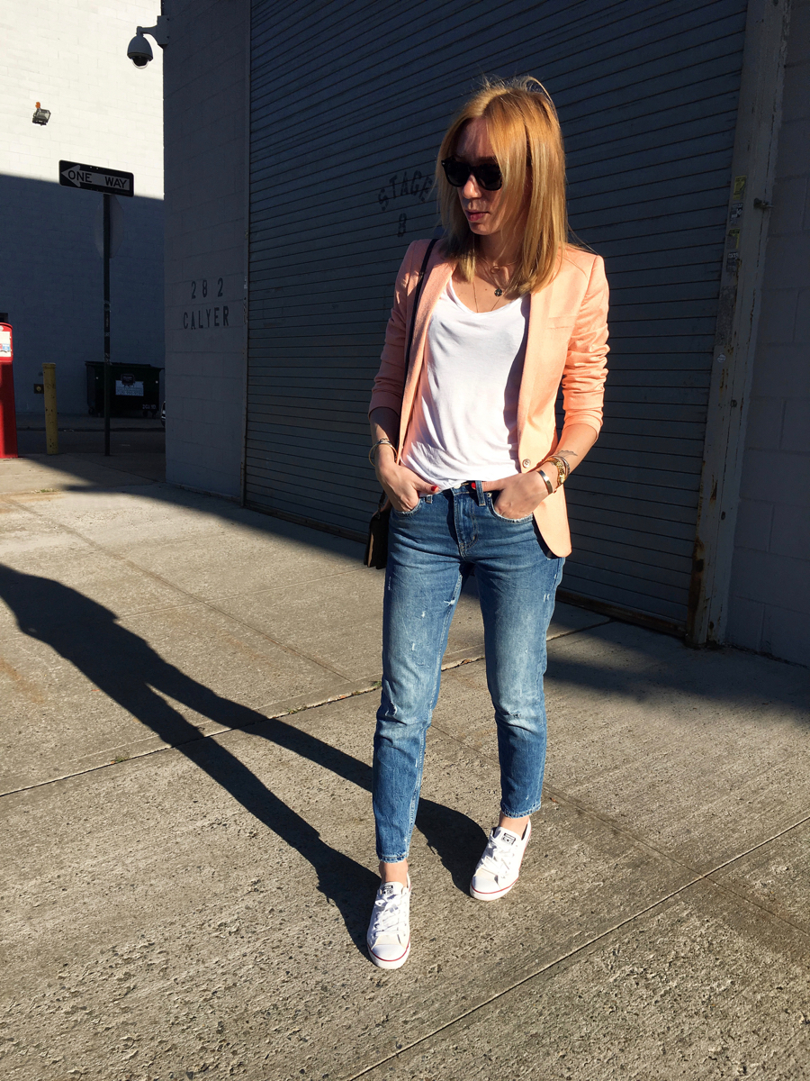 Woman posing on street in neon colored blazer