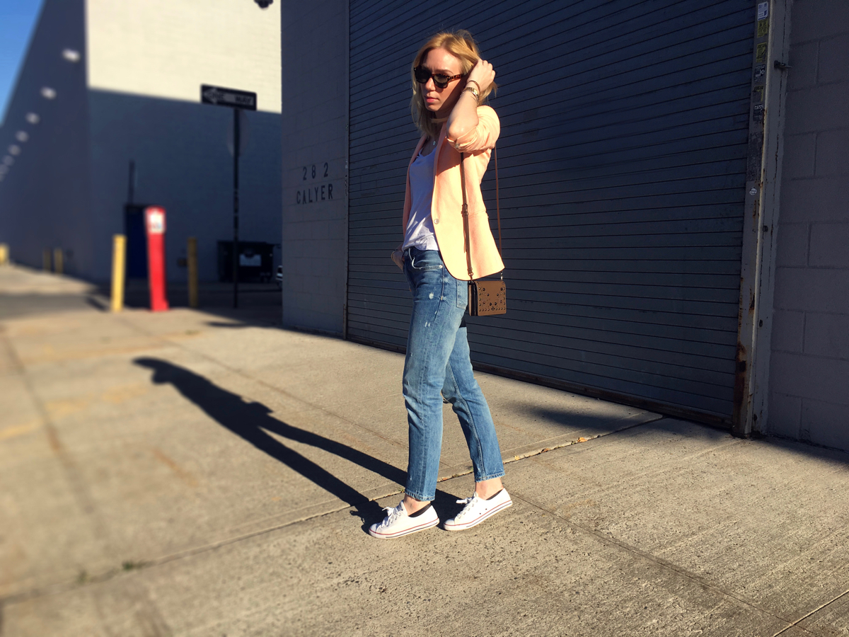 Woman posing sideways wearing neon colored blazer