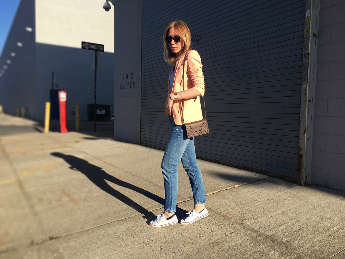 Woman standing sideways posing in neon colored blazer outfit