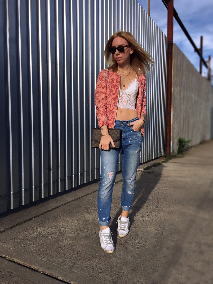 White lace top and pink bomber jacket with jeans outfit