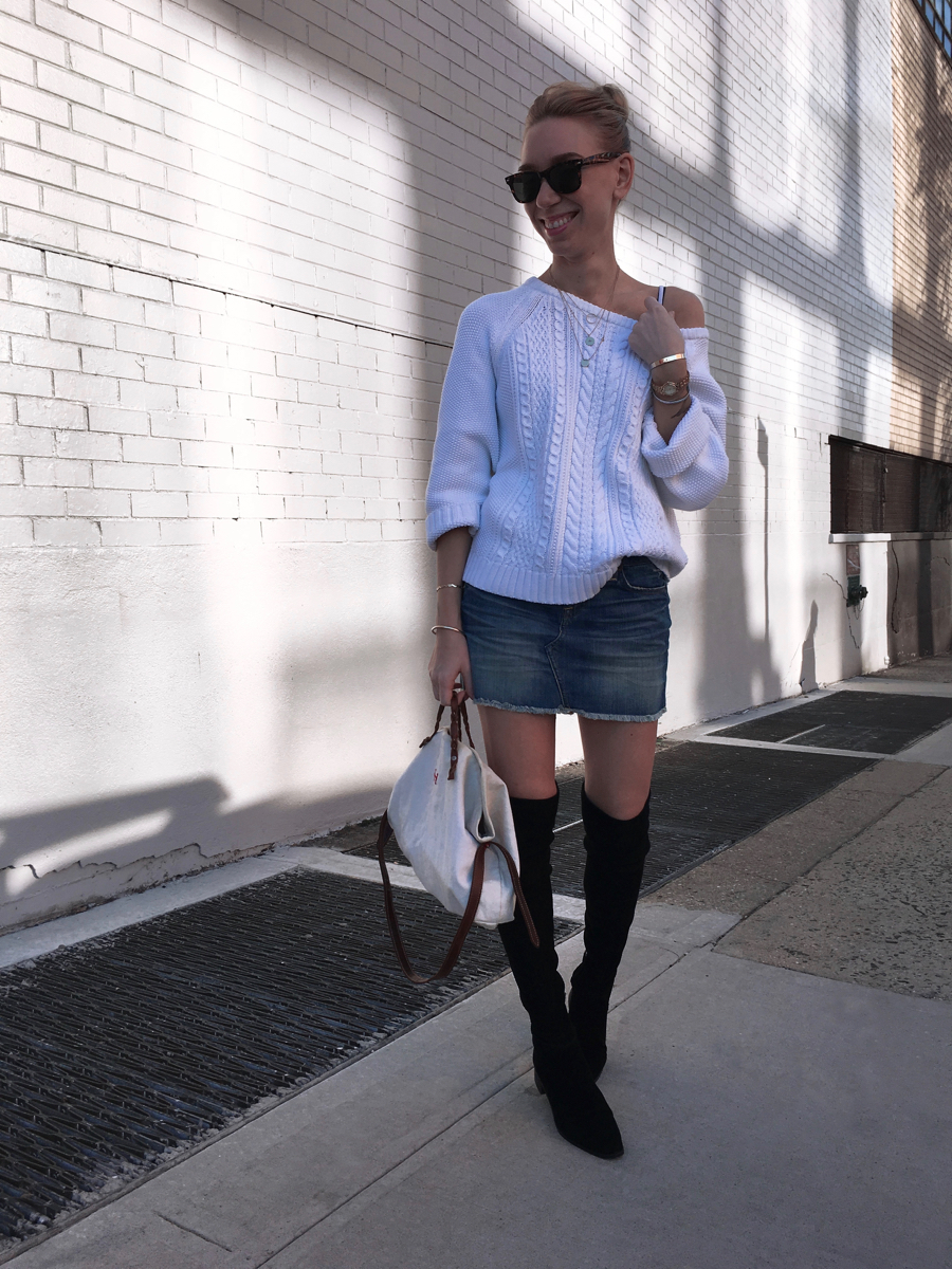 White oversized sweater and denim skirt with black boots outfit