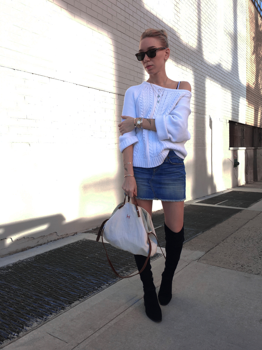 White sweater with denim skirt and black boots outfit