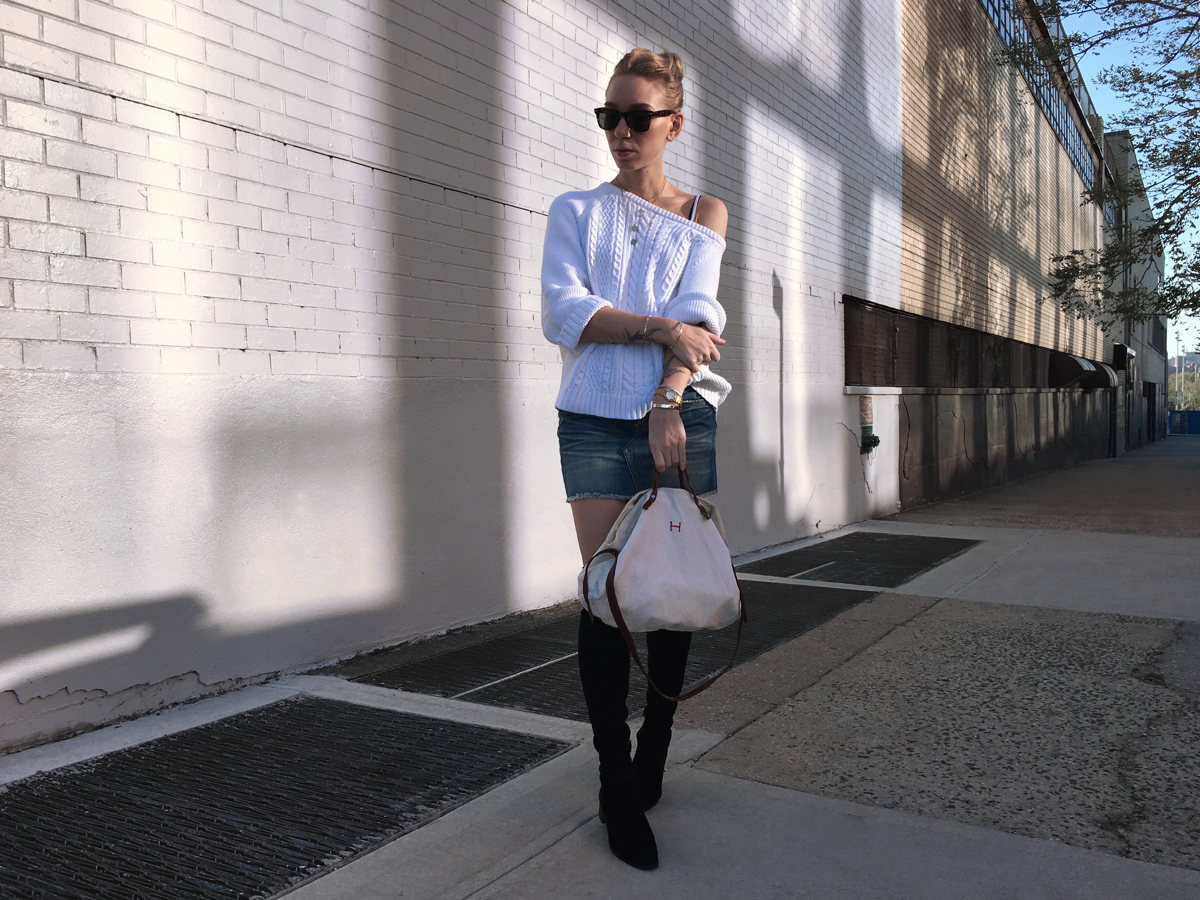 White oversized sweater with denim skirt and black boots outfit