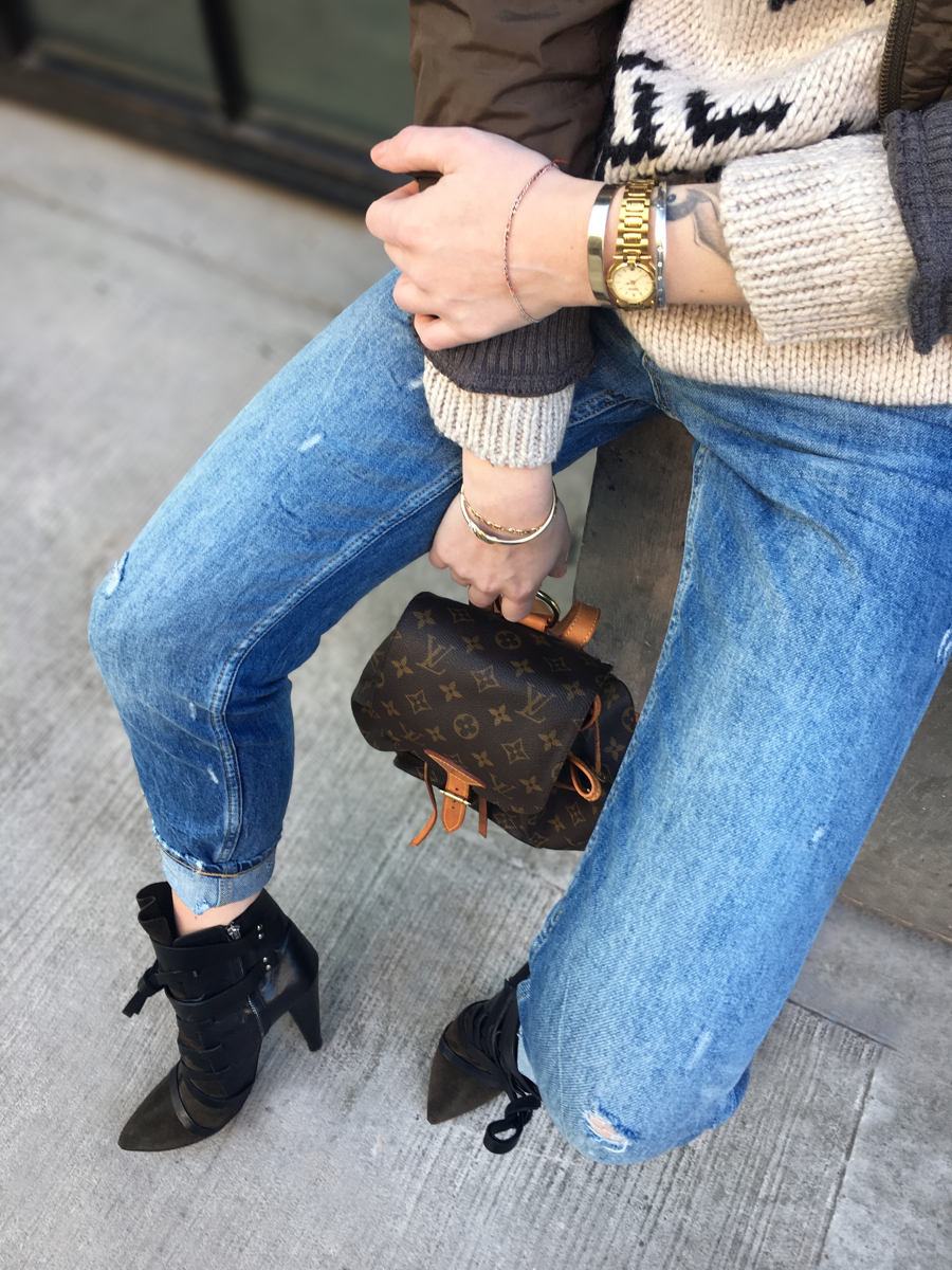 Detail shot of jeans with heels and Louis Vuitton bag