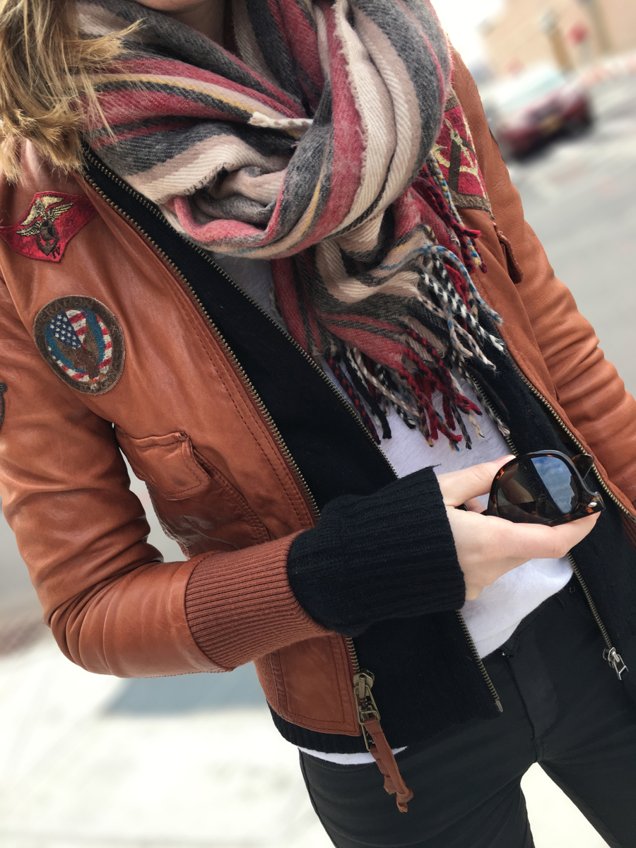 Detail shot of brown leather jacket with patches