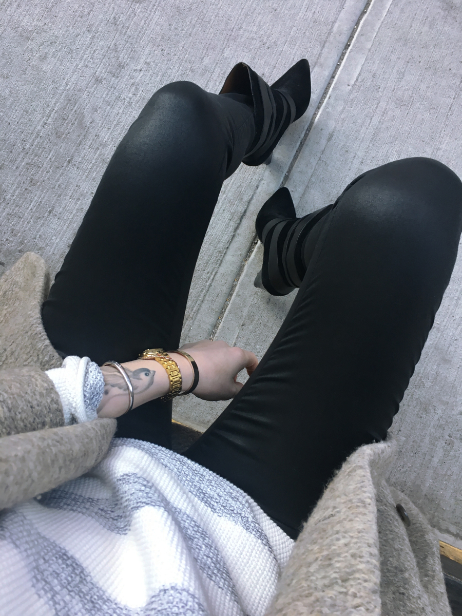 Detail shot of black jeans and striped sweater