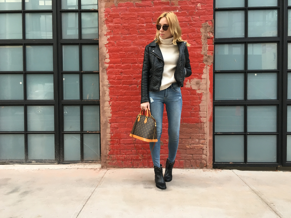 Woman posing in front of red brick wall