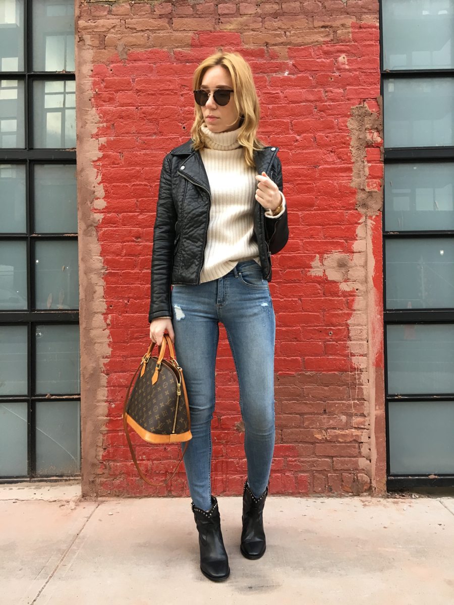 Woman posing in front of red brick wall