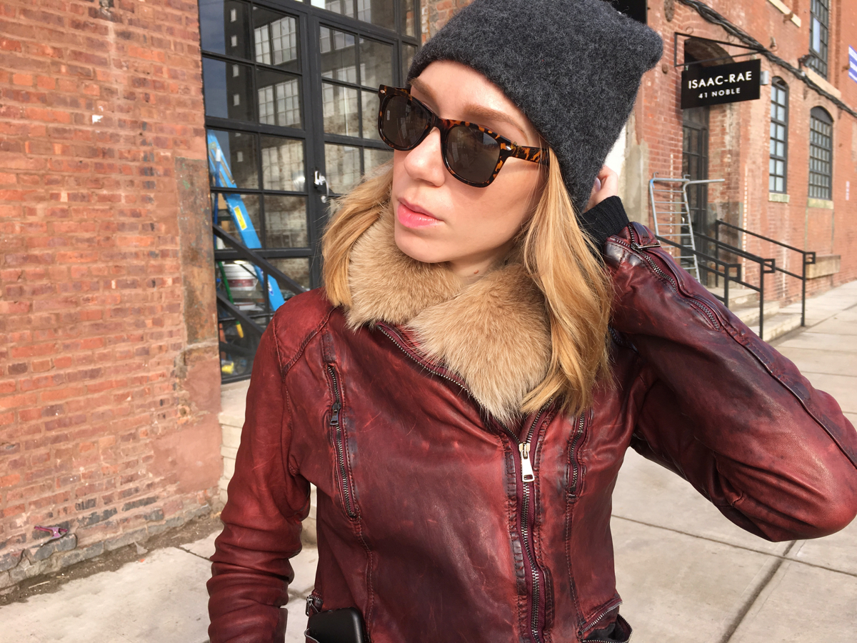 Woman looking sideways wearing a hat