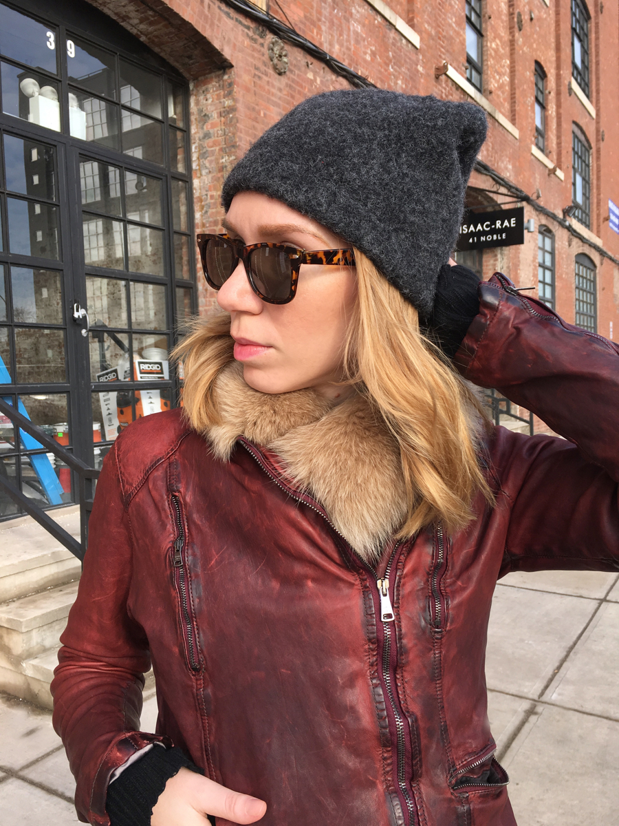 Woman looking sideways wearing a hat