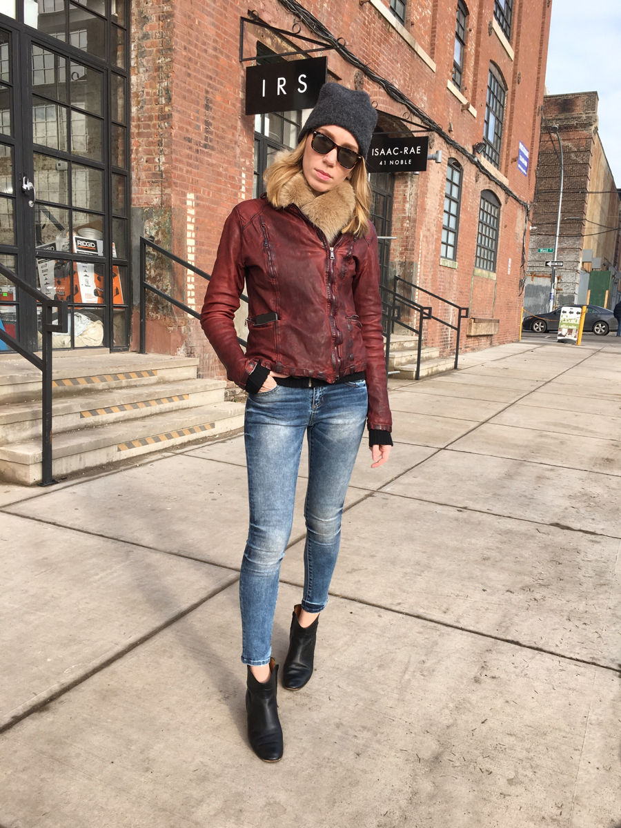 Woman posing in denim and leather outfit