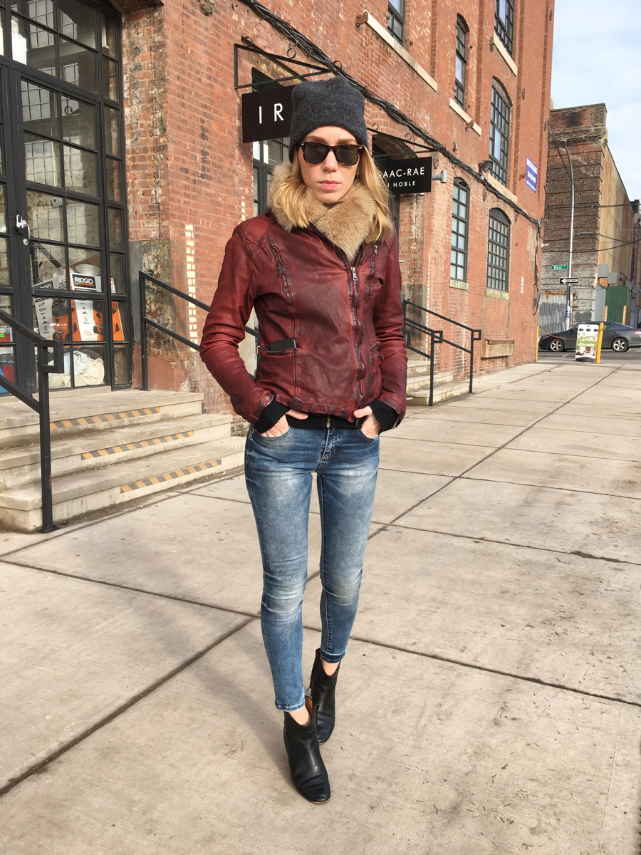 Woman posing in jeans and leather jacket