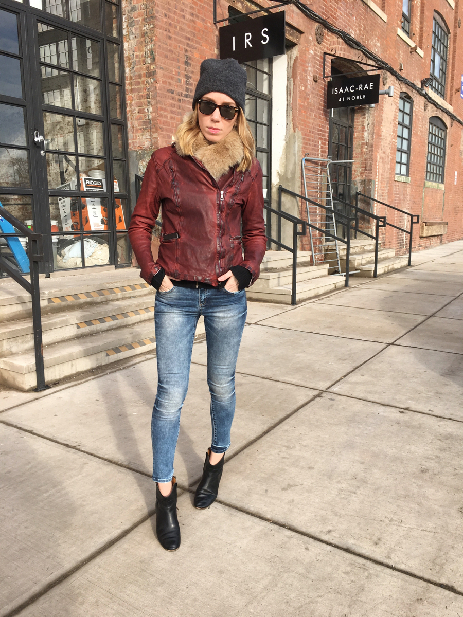 Woman posing in denim and leather outfit
