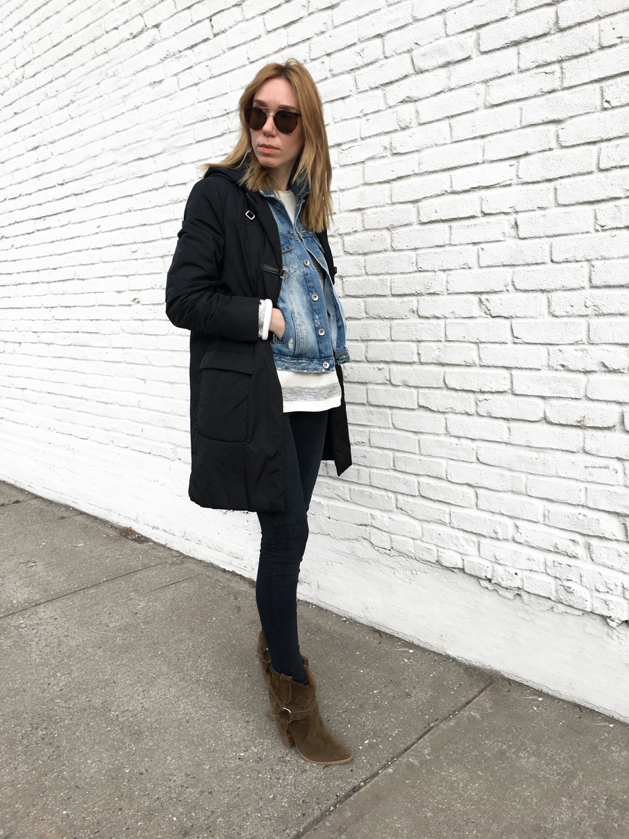 Woman posing in outfit against white wall