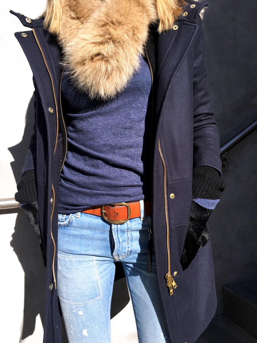 Detail shot of navy coat with fur vest