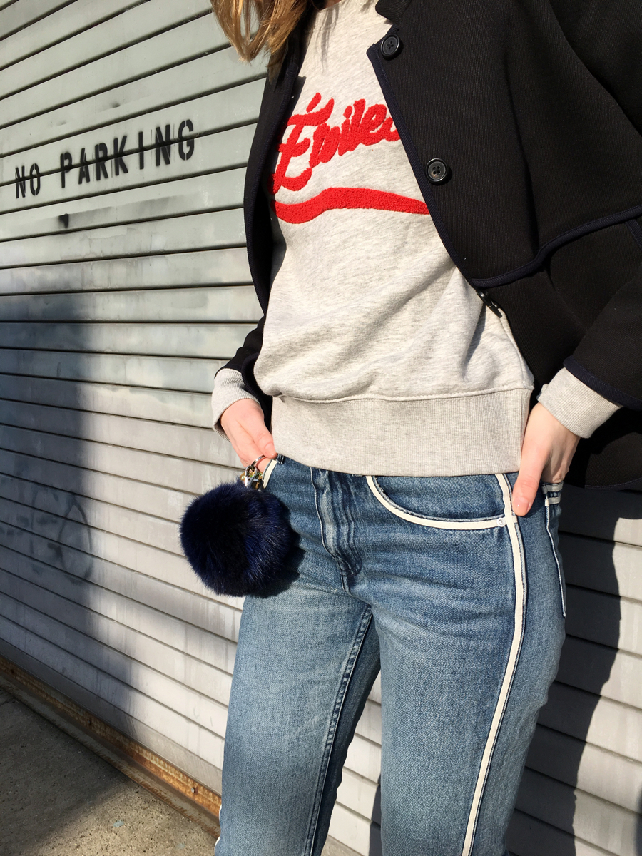 Detail shot of grey sweatshirt and navy coat