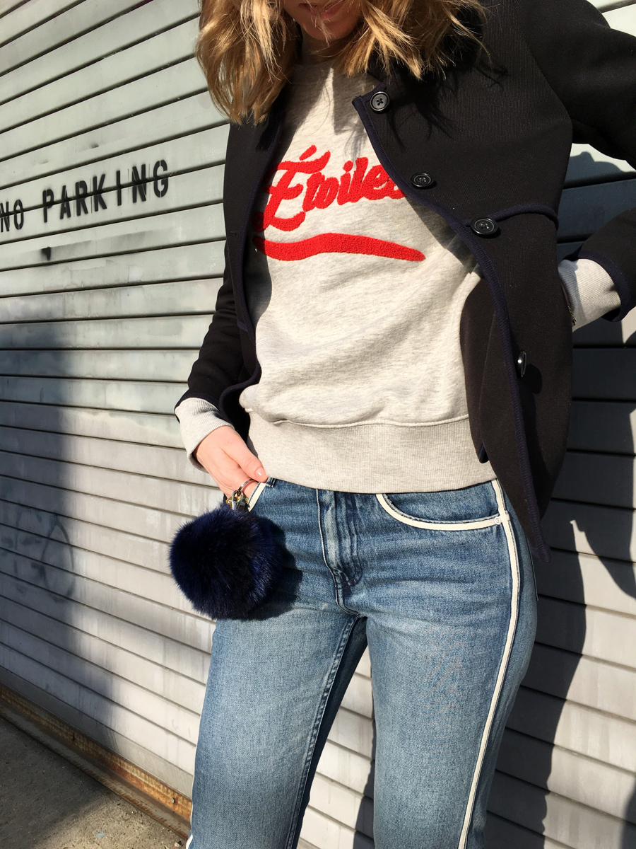 Detail shot of navy jacket with grey sweatshirt
