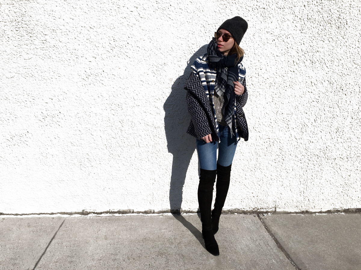 Woman posing in outfit against white wall