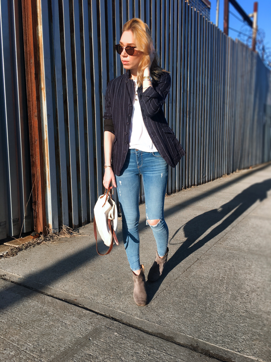 Woman posing in denim with a white tee and linen blazer