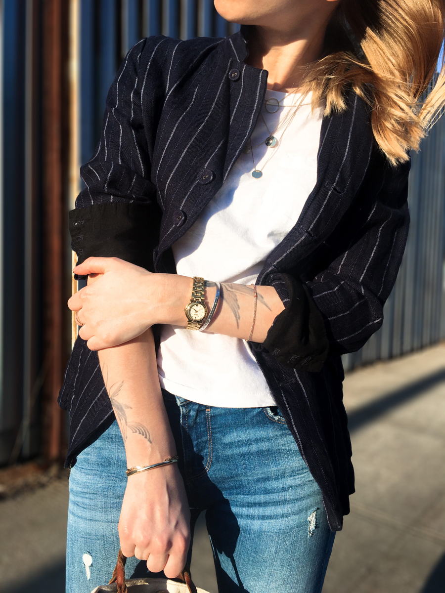 Detail shot of white tee and navy pinstripe blazer