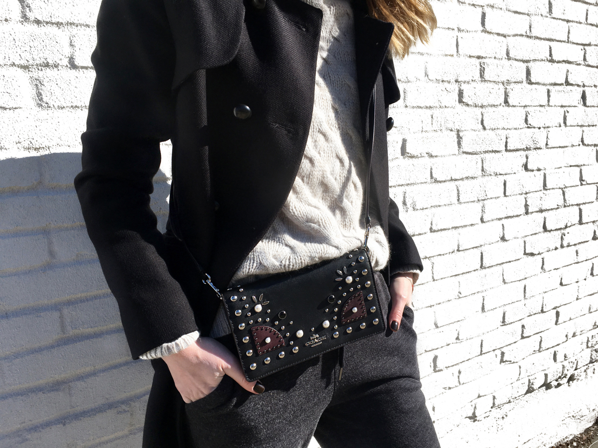 Detail shot of sweater with Coach bag