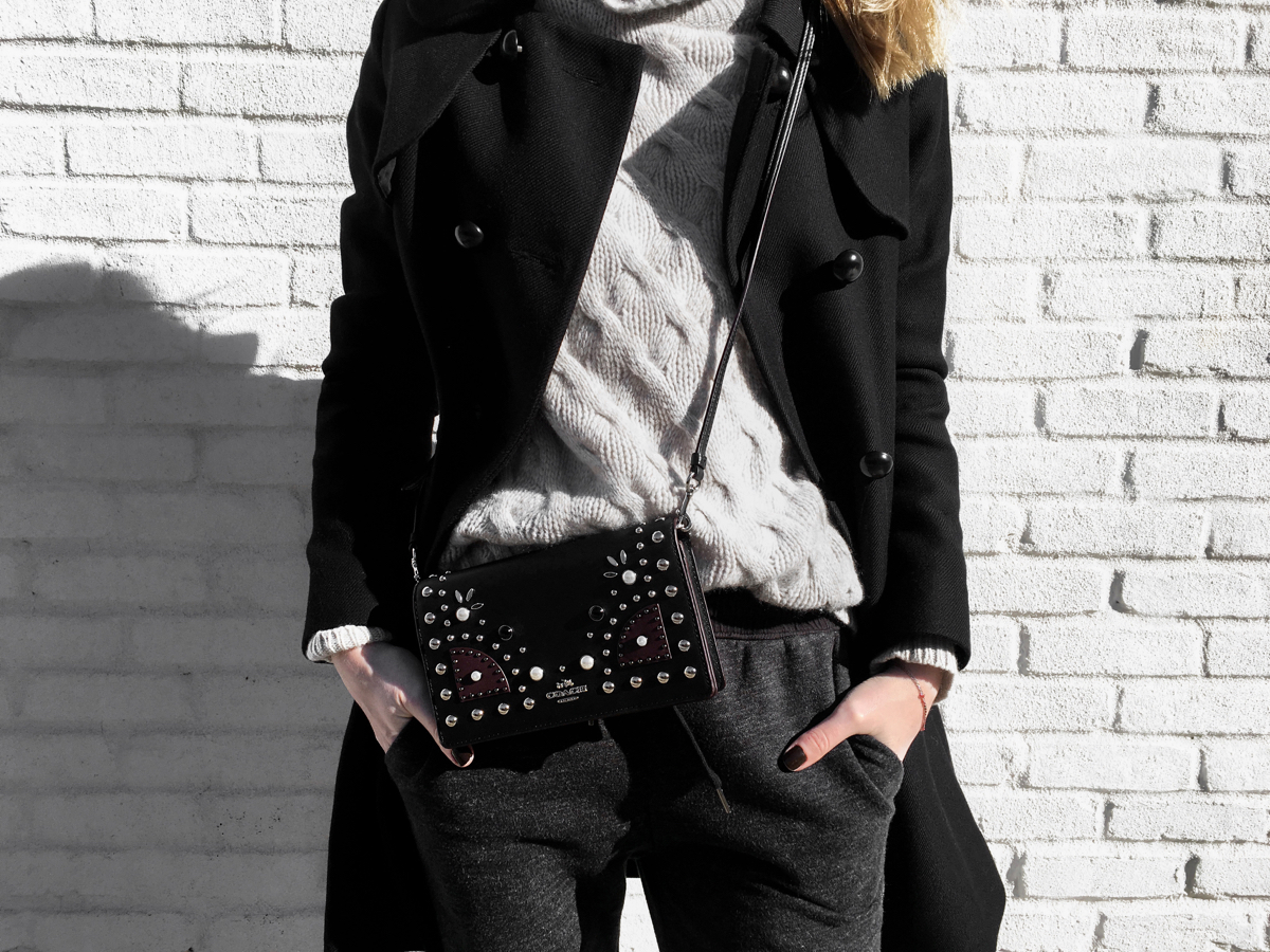 Detail shot of sweater and Coach bag