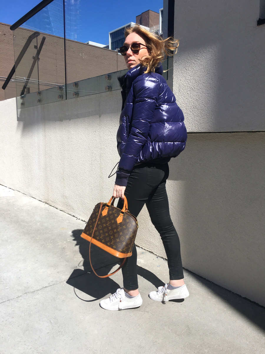 Woman posing sideways in street style photo