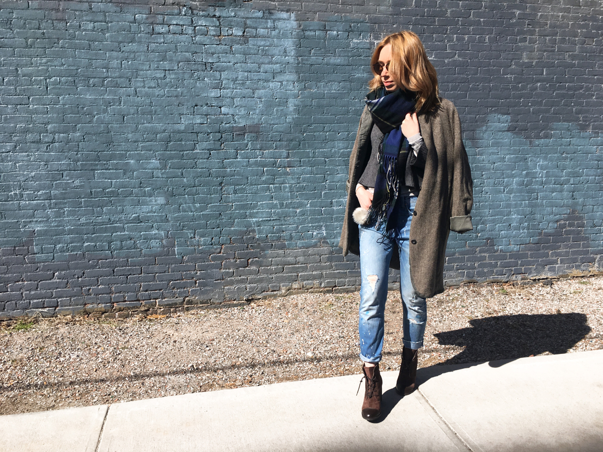 Woman posing in street style photo wearing coat and jeans