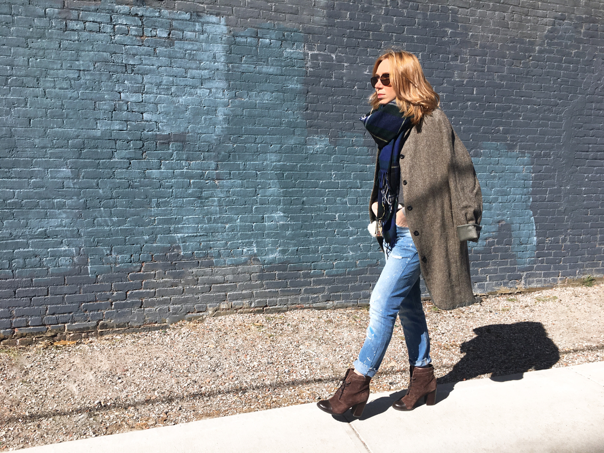 Woman walking in outfit against blue background