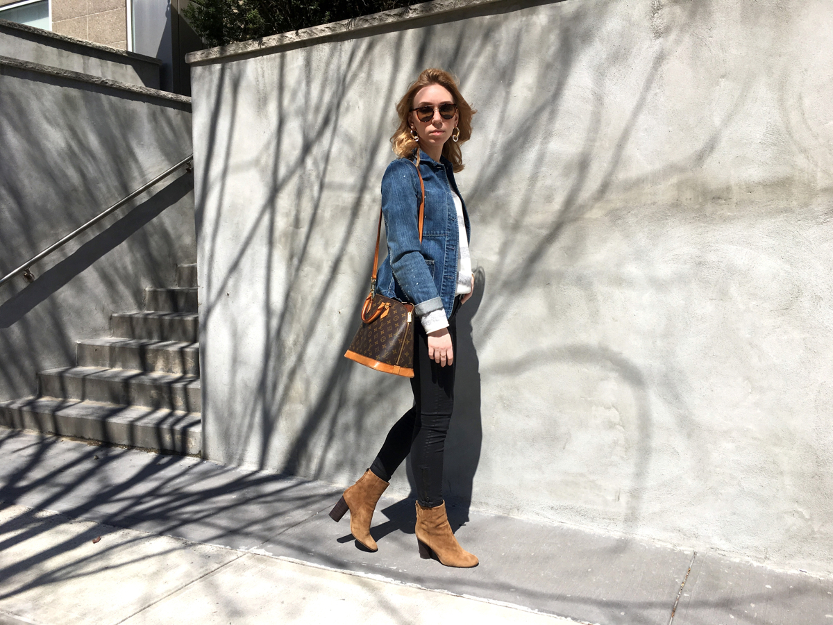 Woman walking in street posing for photo in outfit