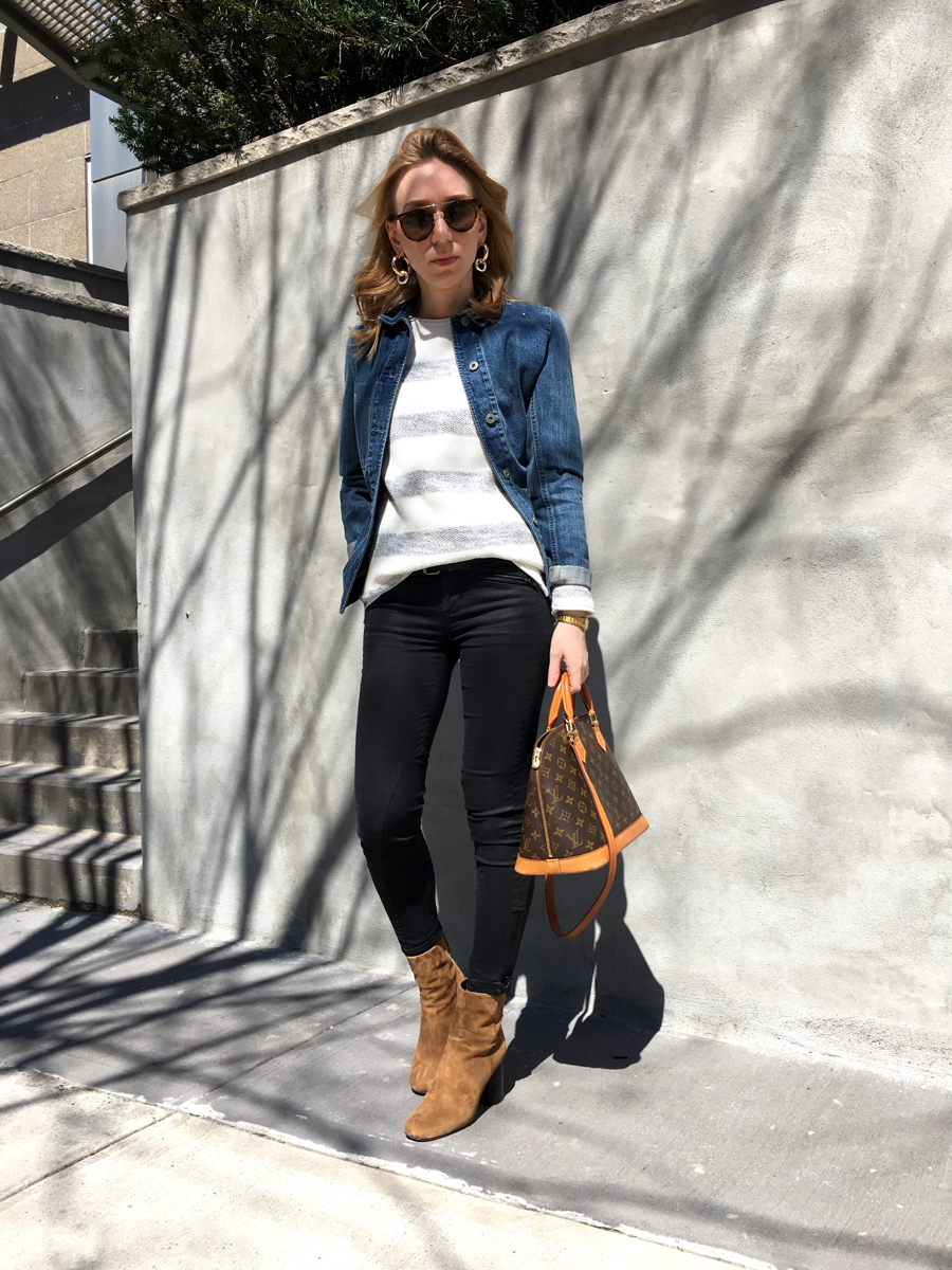 Woman wearing denim jacket outfit posing for street style photo