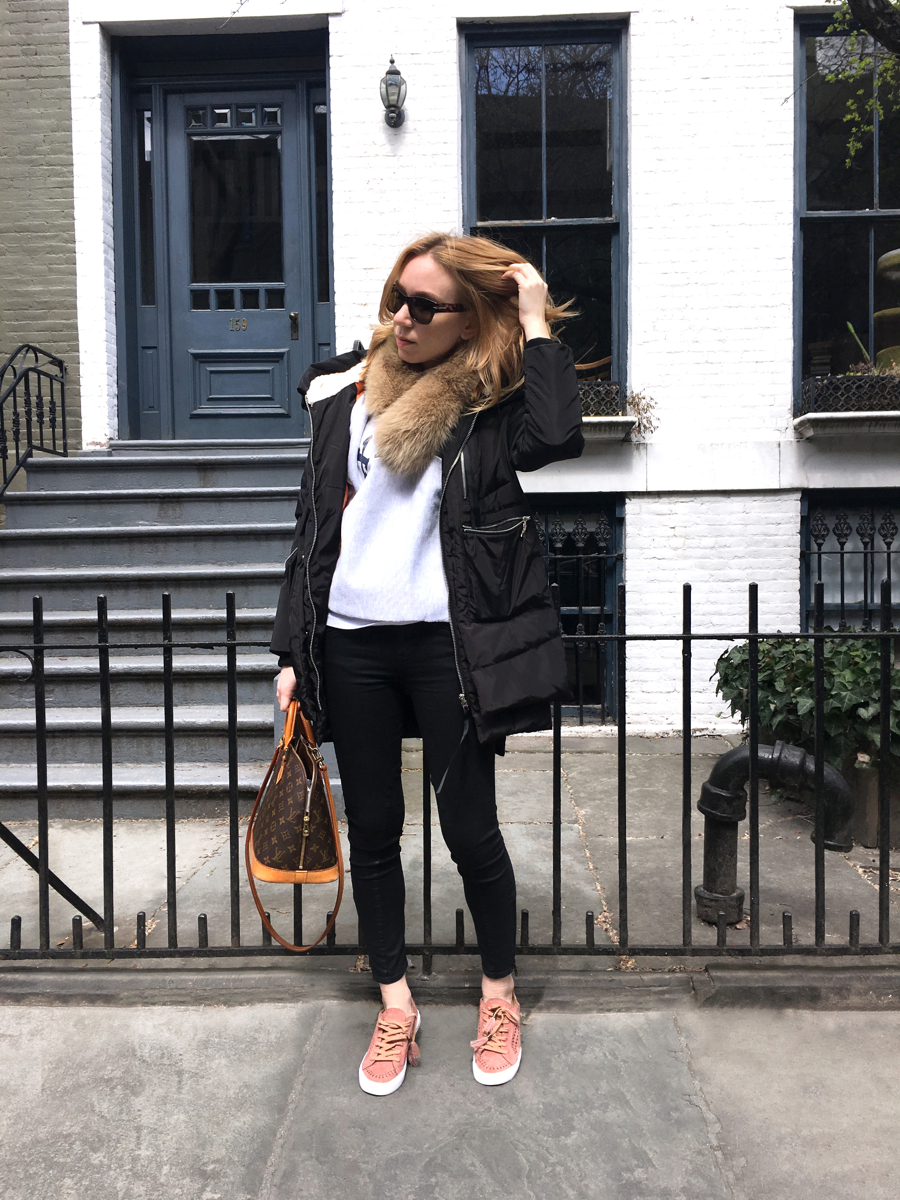 Woman posing in outfit in front of white house