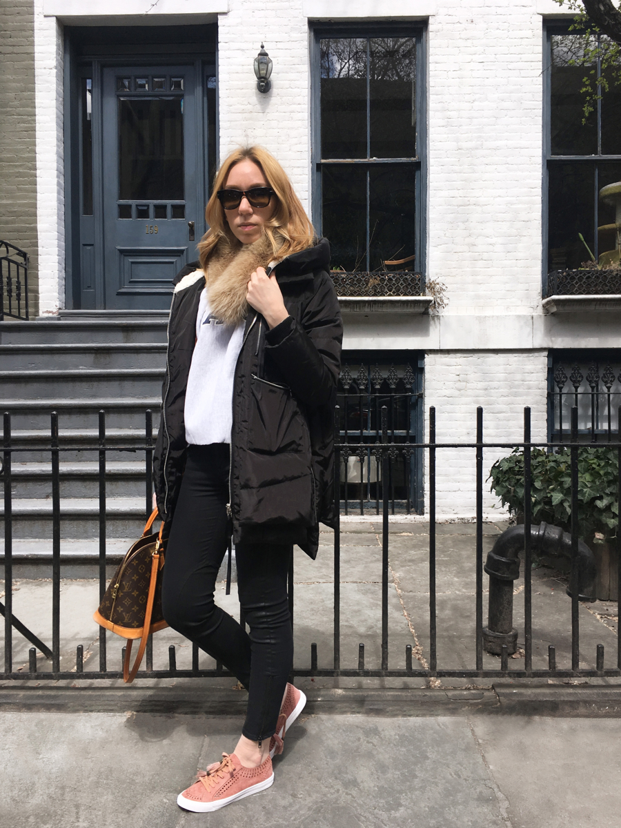 Woman standing in front of house posing in outfit