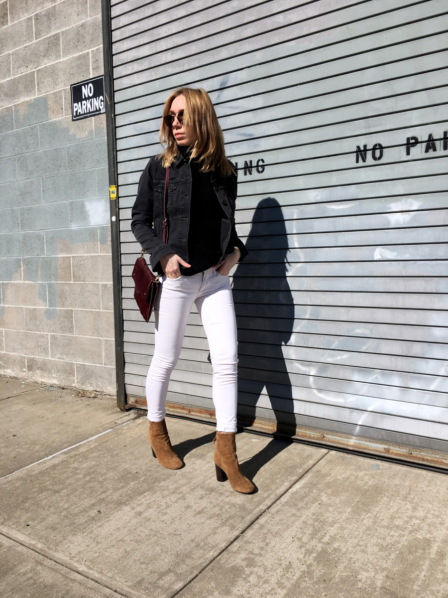 Woman posing in street wearing white denim