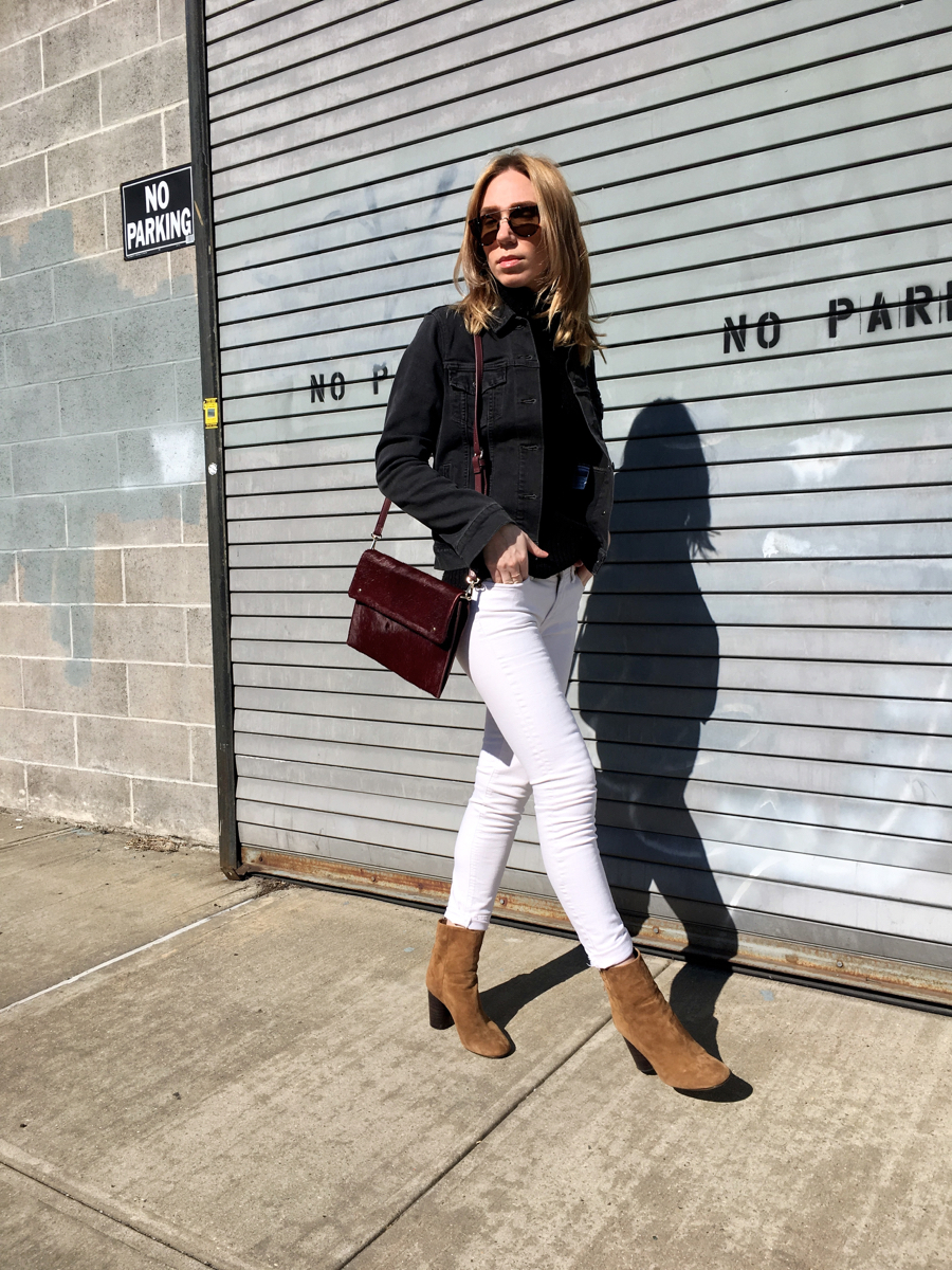 Woman walking in street wearing denim outfit