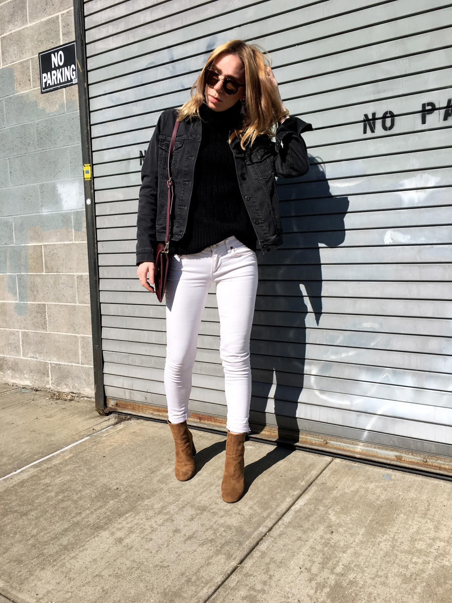 Woman posing with hand on head wearing white and grey denim