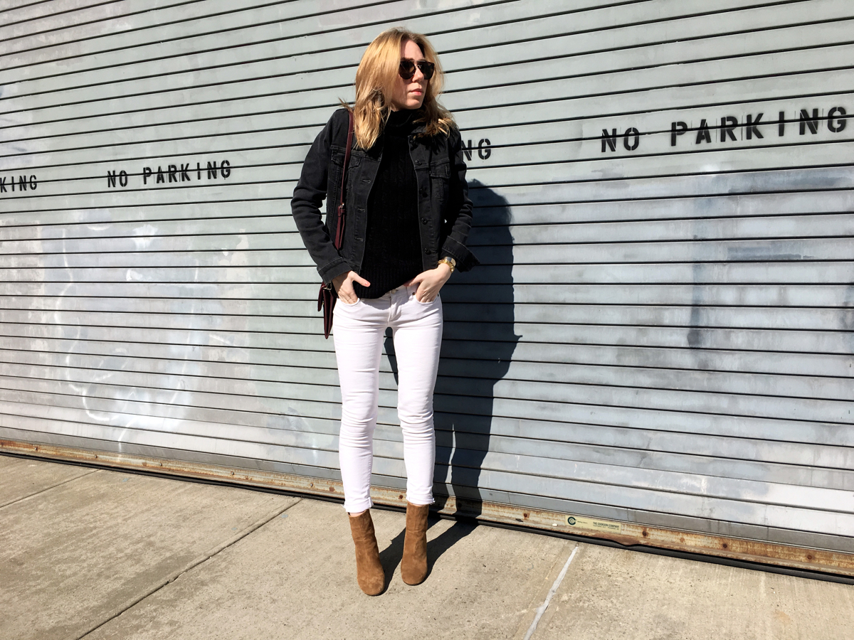 Woman posing in street wearing white and grey denim