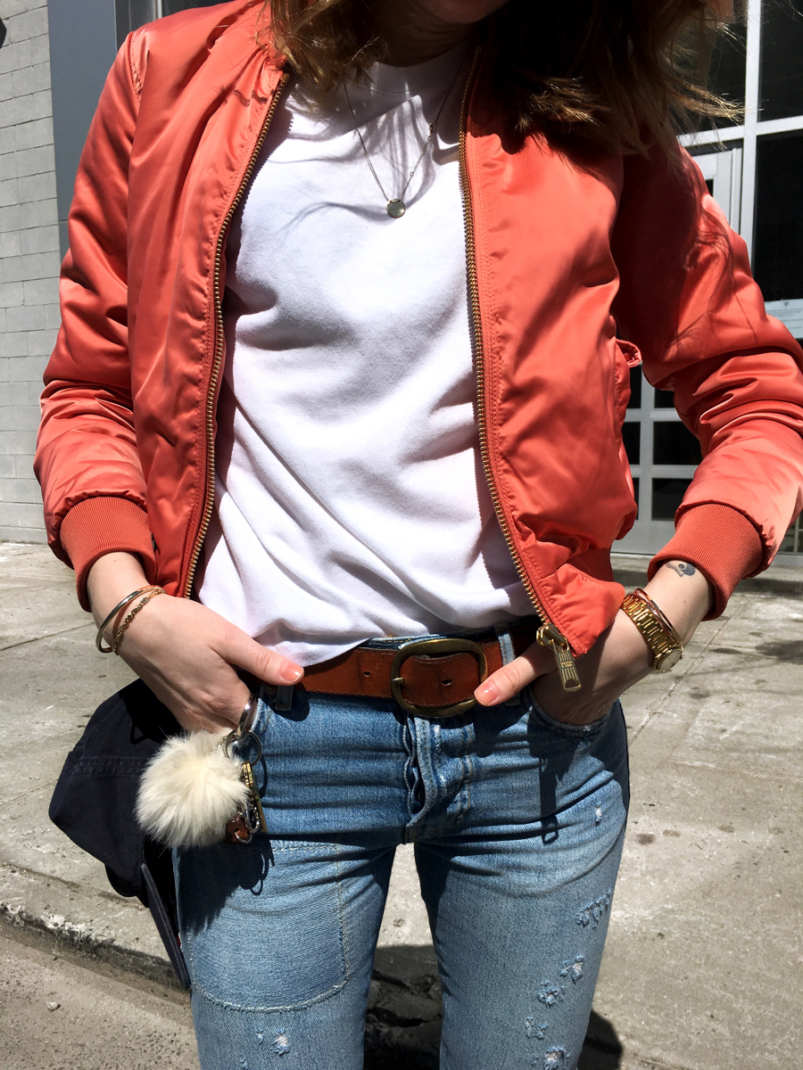 Detail shot of pink bomber with white T-shirt and jeans