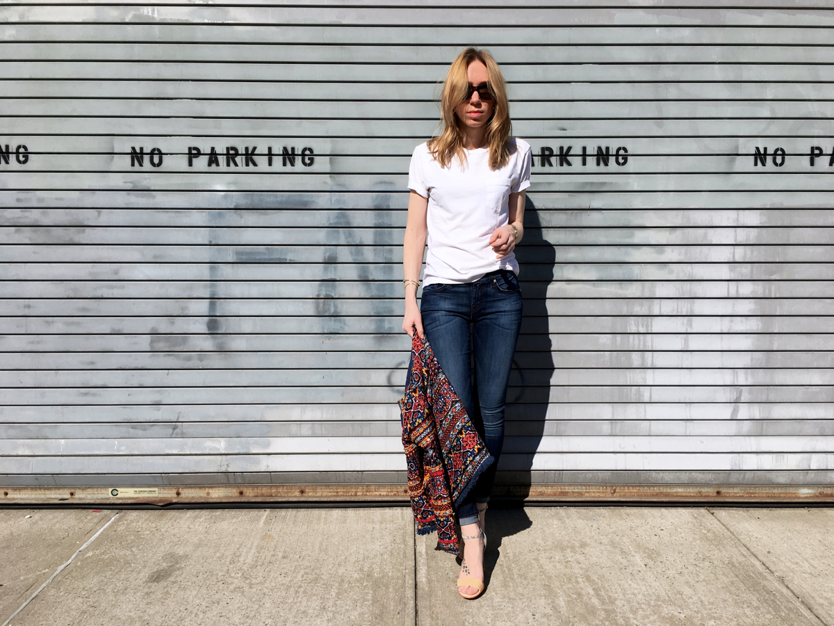Woman holding embellished jacket for style photo