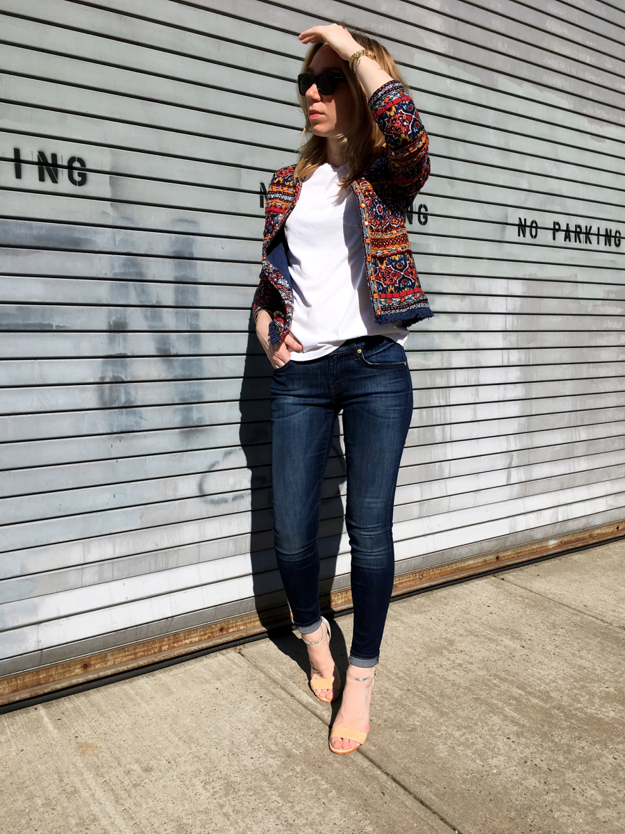 Woman posing in embellished jacket outfit